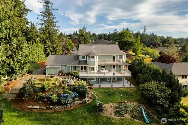 Beautiful landscaped backyard complete with playhouse, raised garden beds and even a chicken coop. Beautiful landscaped backyard complete with playhouse, raised garden beds and even a chicken coop.