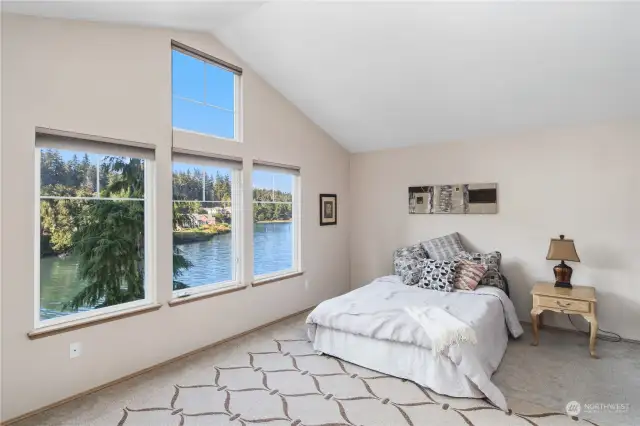 Primary bedroom with windows to enjoy the water views.