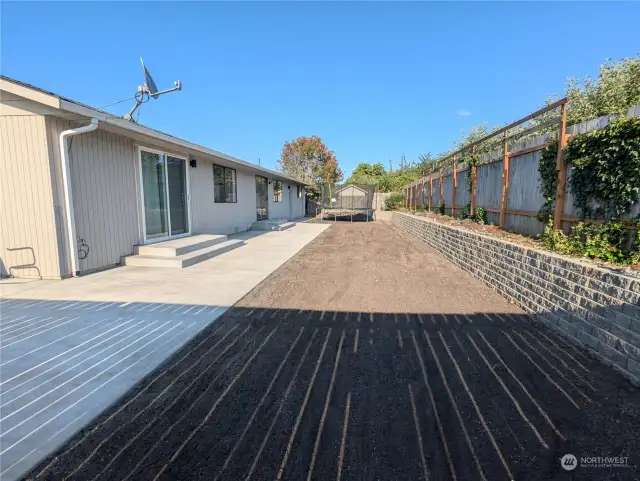 Brand new back yard with rock wall