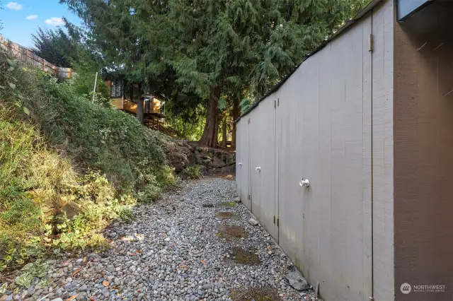 Wood shed building behind the brick wall you see from the driveway.