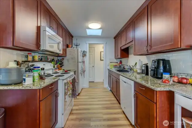 Unit #1 Kitchen. Updated with granite countertops and white appliances.