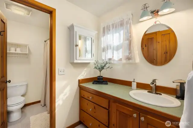The main floor bathroom is accessible from both the primary bedroom as well as the hallway. Separate shower and toilet area. New floors in the bathroom.