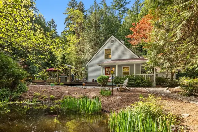 A charming look from the pond to the side wrap around deck and a peek at the back deck. birds love this pond. Sit and relax and take in the wildlife from your own home.