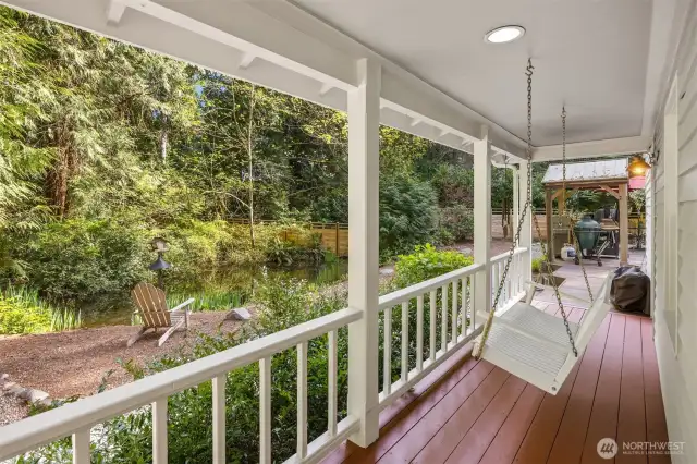 Relax in the porch swing overlooking the pond area. the wrap around deck leads to the large back deck.