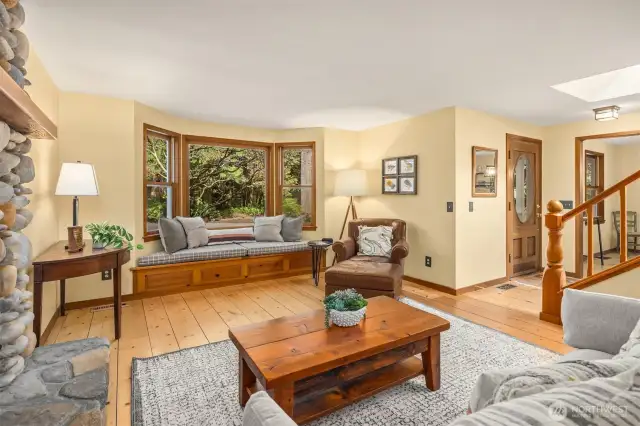 A look at the living room and home entrance. Notice the unique wood floors.