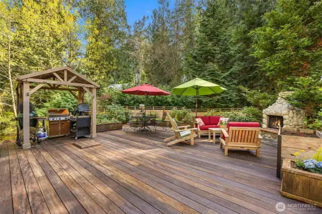 A covered BBQ area and plenty of dining and relaxing space on this stunning deck.