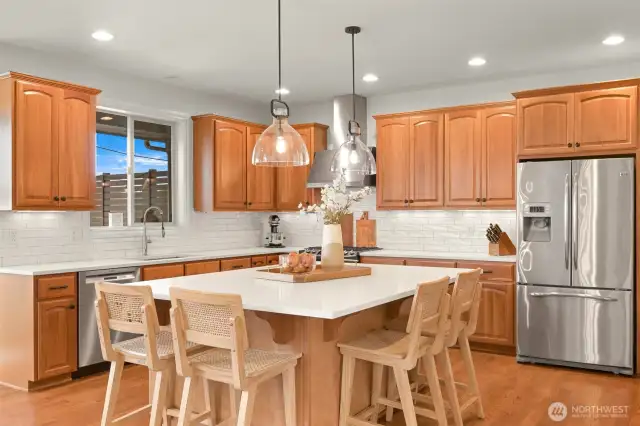 Modern Quartz countertops, undermount sink, and subway tile backsplash.