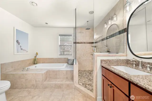 Primary ensuite with tub, walk in shower, and a double vanity