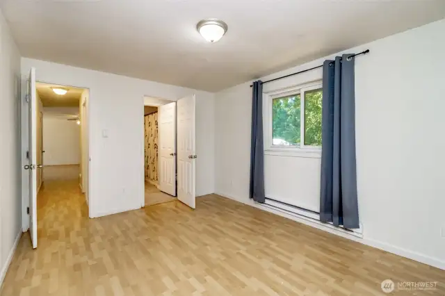 Primary bedroom with half bath and walk-in closet.