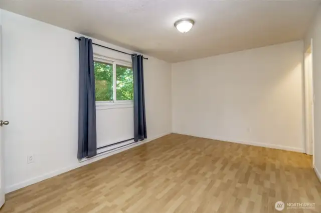 Primary bedroom with half bath and walk-in closet.