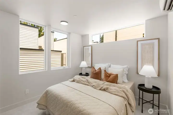 Light-filled bedroom with calming finishes and a modern aesthetic.