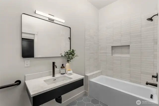 Spa-inspired bath with floor-to-ceiling tile and walk-in shower.