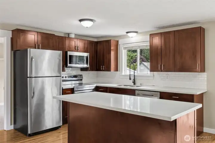 Gorgeous kitchen with quartz counters and plenty of storage.