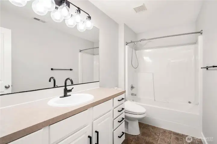 Upstairs guest bathroom with tub