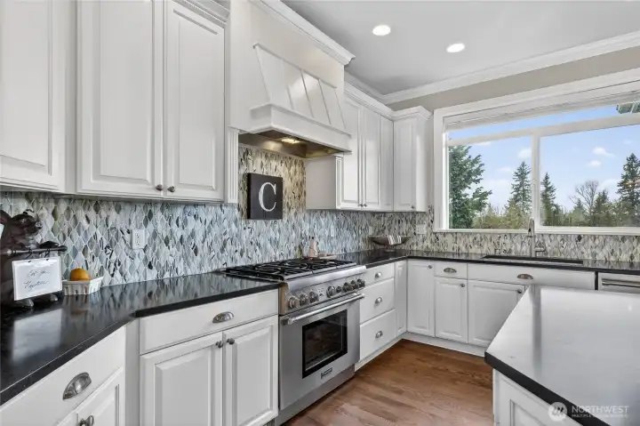 Gourmet kitchen opens into family room & built-in wine bar