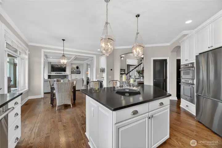 Gourmet kitchen opens into family room & built-in wine bar