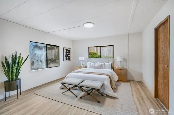 The primary bedroom is oversized and has so much light.