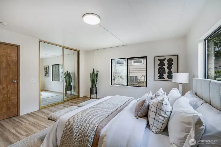 The mirrored closet doors makes the room feel and look even bigger.