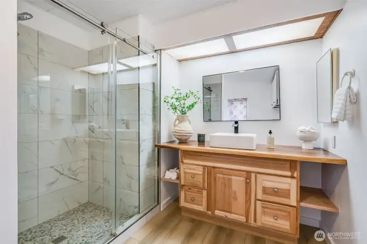 Nice roomy step in shower and an updated vanity.