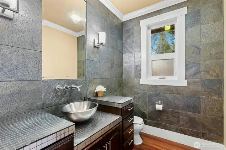 Beautifully appointed main-level powder room featuring refined craftsmanship and intricate detailing.