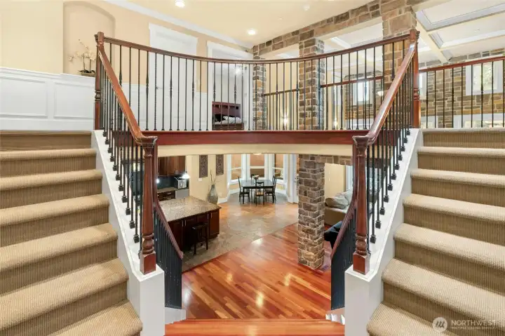 Elegant dual staircases to the main floor, highlighting the home’s striking architectural presence and solid craftsmanship.