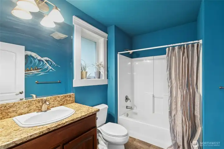 Secondary bedroom with private en-suite bath and beautifully finished custom paint detailing.