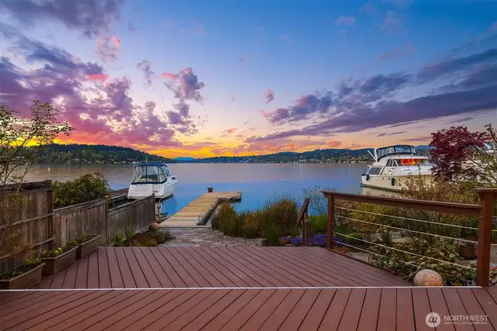 The deck extends the outdoor usable entertaining area and flows into stone patio and dock.