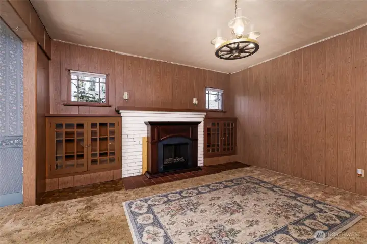 Primary living area with a fireplace and custom built-ins