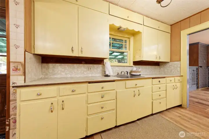 Galley kitchen with a convenient side entrance from the carport.