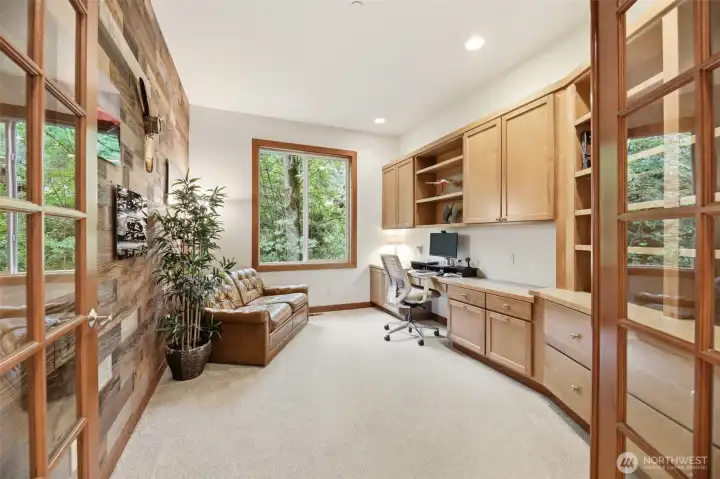 French doors into the office with built in custom cabinets and a private wooded view. French doors into the office with built in custom cabinets and a private wooded view.