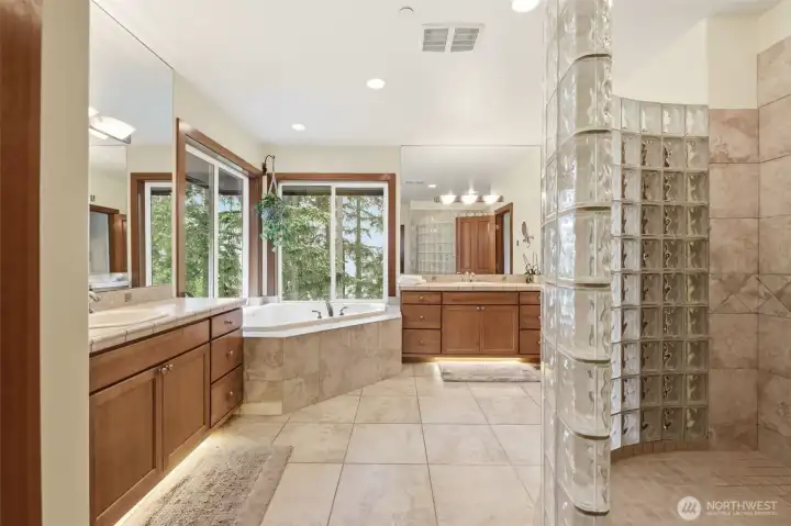 Spa-inspired primary bath is a beauty! Another opportunity to take in the gorgeous trees surrounding. Spa-inspired primary bath is a beauty! Another opportunity to take in the gorgeous trees surrounding.