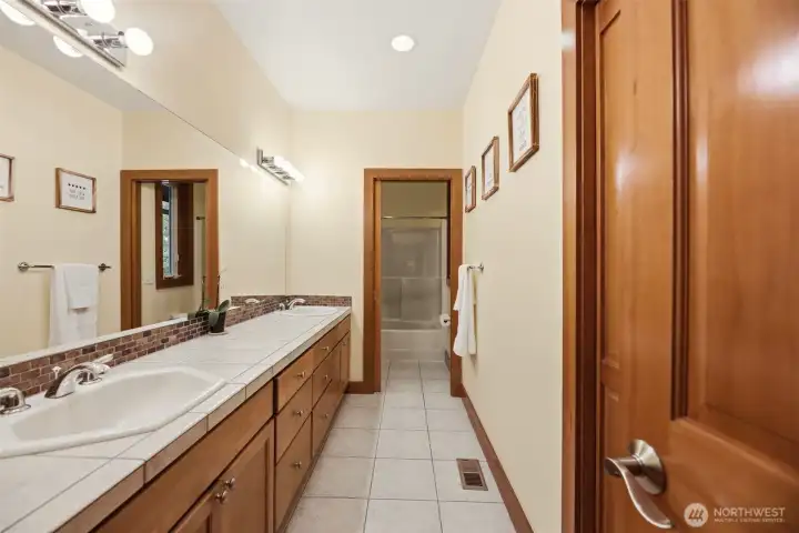 Upstairs full bathroom with double sink. Upstairs full bathroom with double sink.