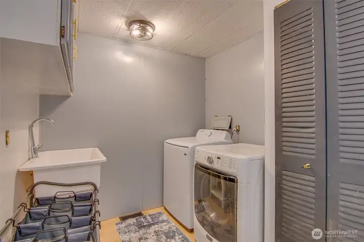 Main Laundry with washer/dryer and utility sink
