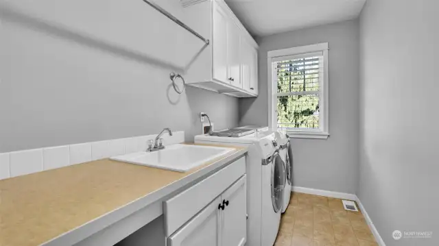 Conveniently located on the second floor is your laundry room with tons of storage space, drying rack, and handwash sink.