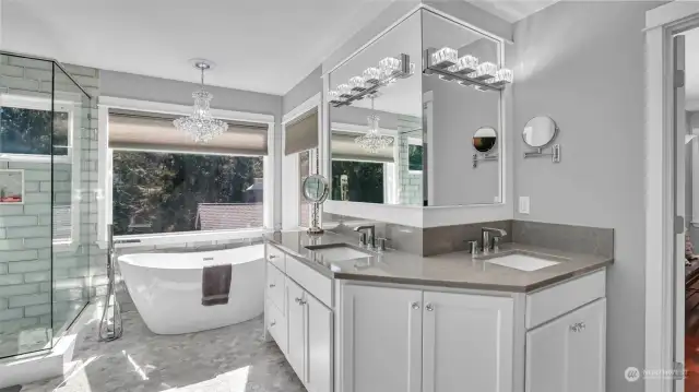 Beautiful chandelier above the large soaking tub with serene views make this en-suite a dream!