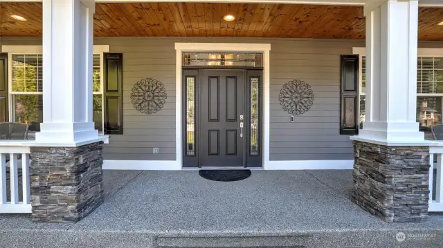 Front of the home offers a welcoming feel with craftsman style entry and beautiful landscaping.