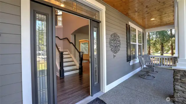 Stunning covered porch is the perfect place to sit and enjoy this quiet neighborhood.