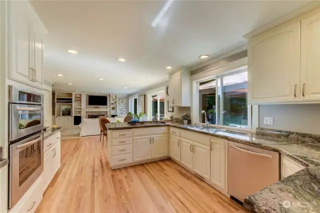 Nice kitchen with white cabinets, granite counters and hardwood floors
