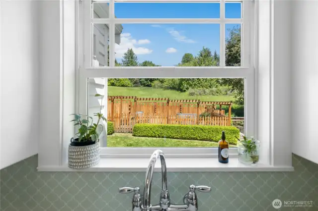 Looking out the kitchen window to the fenced vegetable garden.