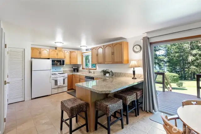 The kitchen has granite counter tops, and opens to the dining area and deck for convenient entertaining.