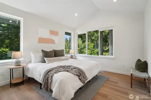 Photos of staged unit, 20313A. Primary bedroom with vaulted ceilings