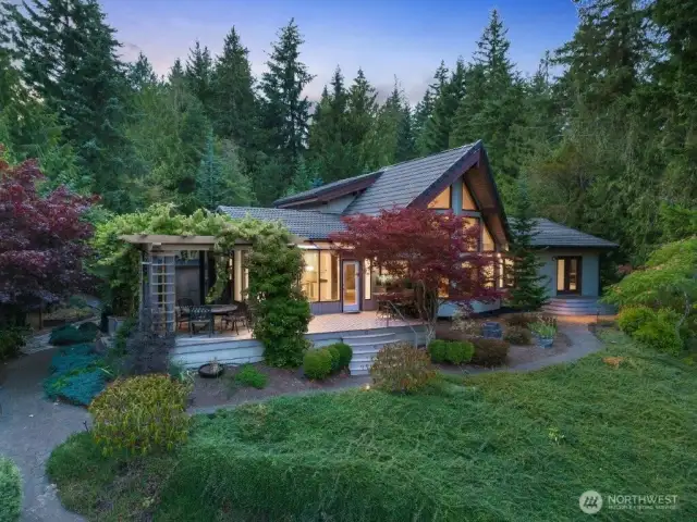 The home fits naturally within the landscaped lot and features wonderful lake and territorial views. There is also a 1,080 SF double door shop on the upper section.