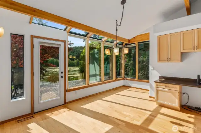 The views and natural light continue in the sunroom style nook off of the kitchen.