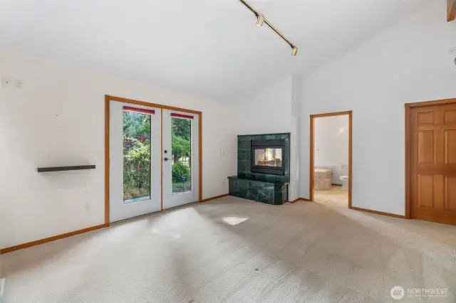 Primary bedroom with french doors leading to the waterfront side of the home.