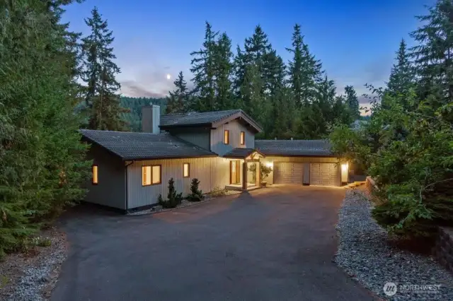 The home fits naturally into the landscape and features lake a territorial views.