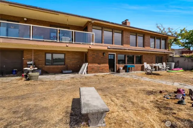 The first floor has a tremendous amount of windows for viewing the lake, and on the bottom floor, you have a one-car garage/storage space as well as the door for entering at this level.  There is a full kitchen on the bottom floor, so with separate access, you could put a driveway and parking down here.  It's up to your imagination!