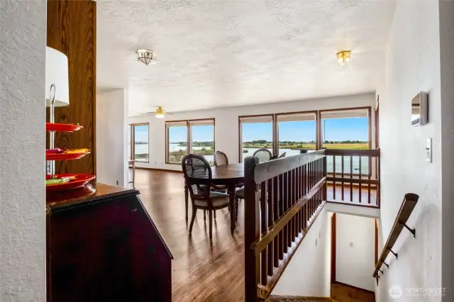 As you walk into the front single door of the home and take off your shoes, you can either go straight downstairs to the second living quarters or on into the dining area. Check out the sweeping view of the lake!