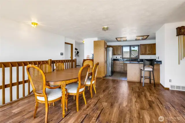 If you love an open concept floor plan, this is it! The vinyl plank flooring makes it easy to clean, and the granite counters in the kitchen are nice and cool in the summertime. The stairs for the basement floor are on the left.