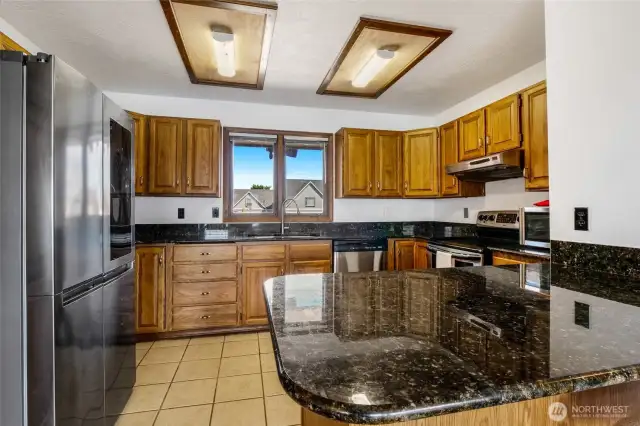 All appliances come with this home: stainless steel refrigerator, dishwasher, stove/range, microwave, and SS stove vent. Plenty of cupboards, and there's a huge storage pantry in another part of the house.