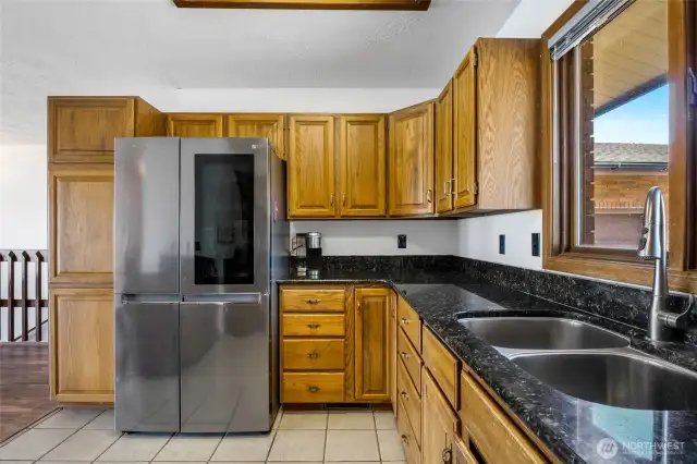 The beautiful cupboards, counters, and stainless steel appliances are so appealing and the refrigerator might show you what's inside if you tap on it!